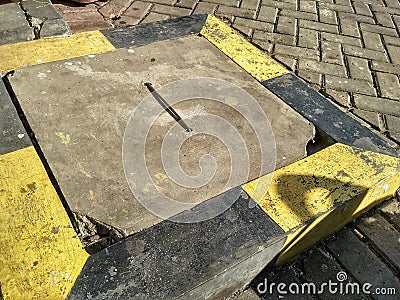 cover the sewer holes or waterways with yellow and black line markings Stock Photo