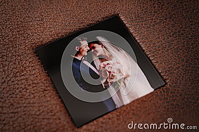 cover of wedding photobook in brown leather binding with photos Stock Photo