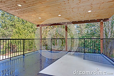 Covered deck with wooden ceiling and iron handrails. Stock Photo