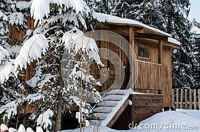 Fabulous wooden hut covered with snow in the forest Stock Photo