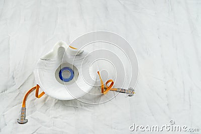 COVID-19 concept. Face mask on white sheet Stock Photo