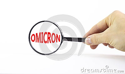 Covid-19 corona and omicron symbol. The concept word Omicron. Magnifying glass. Doctor hand. Beautiful white table, white Stock Photo