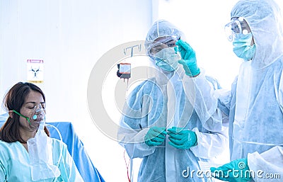 COVID-19, Corona Virus outbreak quarantine epidemic spread social distancing concept. Asian doctors wear PPE suit glove and face Stock Photo