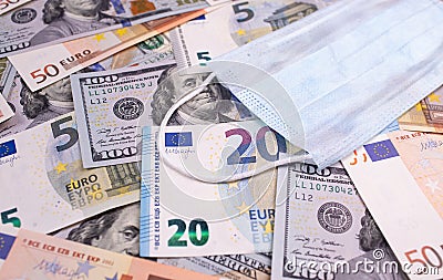 COVID-19 coronavirus, pandemic. Money dollars, euro banknotes bill with face mask. Coronavirus affects global stock market. Crisis Stock Photo