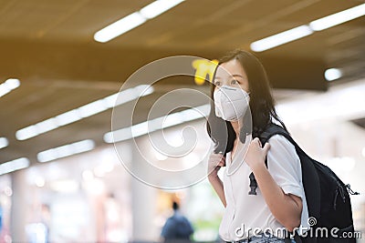 COVID-19 Crisis, Asian travelers girl and surgical mask in airports Stock Photo