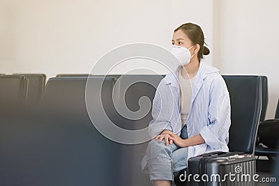 COVID-19 Crisis, Asian travelers girl and surgical mask in airports Stock Photo