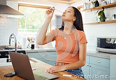 Covid, healthcare and pcr with woman at home for medical, sick and telehealth with laptop and cotton swab test in Stock Photo