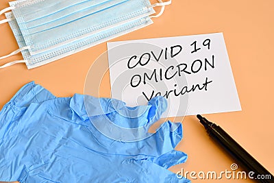 Covid-19 new Omicron variant. Medical face masks, blue medical gloves and marker with white paper and `Covid-19 variant Omicron` t Stock Photo