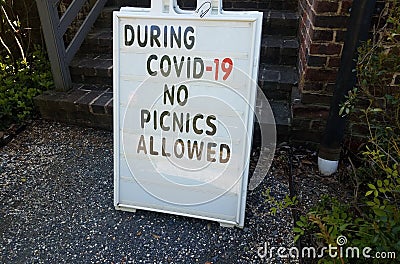 During covid 19 no picnics allowed sign on gravel Stock Photo
