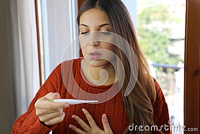 COVID-19 Pandemic Coronavirus Fever Woman Checking Temperature Thermometer Home Shortness of Breath Symptoms SARS-CoV-2. Girl with Stock Photo