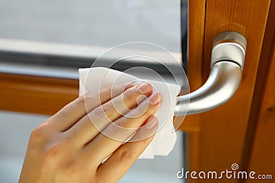 COVID-19 Pandemic Coronavirus Woman Hand Disinfect Doorknob Handle with Wet Wipes Alcohol Cleaning Against Coronavirus Disease Stock Photo