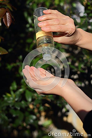 COVID-19 Pandemic Coronavirus woman hands using wash hand sanitizer gel dispenser, against Novel coronavirus 2019-nCoV or Wuhan Stock Photo