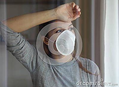 COVID-19 Pandemic Coronavirus Woman Quarantine Home Isolation Wearing Mask Protective Waiting End of Pandemic SARS-CoV-2. Girl Stock Photo