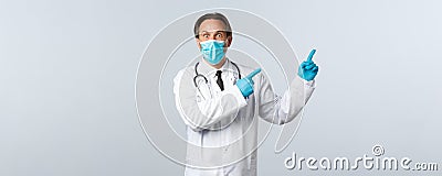 Covid-19, preventing virus, healthcare workers and vaccination concept. Shocked startled male doctor in mask and gloves Stock Photo