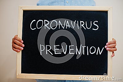 Covid prevention. Coronavirus concept. Boy hold inscription on the board Stock Photo