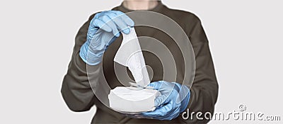 Covid-19 prevention. Female wearing protective rubber gloves opens pack of disinfecting wipes. Coronavirus hygiene Stock Photo