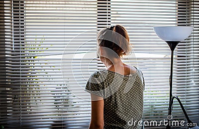 COVID-19 Quarantine mental health. Woman self at home pensive looking out of window thinking of relationship, employment Stock Photo