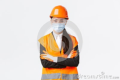 Covid-19 safety protocol at enterpise, construction and preventing virus concept. Confident asian female chief engineer Stock Photo