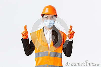 Covid-19 safety protocol at enterpise, construction and preventing virus concept. Hopeful optimistic asian female Stock Photo