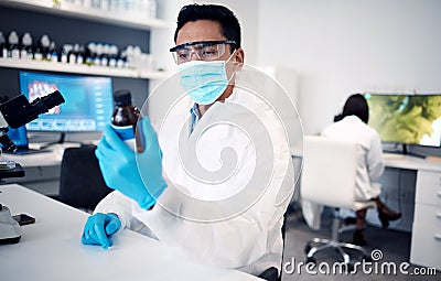 Covid, scientist and man with bottle in laboratory with cure or cough mixture. Science, research and male developing Stock Photo