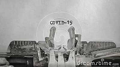 COVID-19 text typed on blank sheet with old typewriter in vintage background Stock Photo