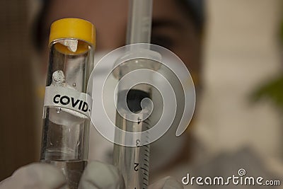 Covid-19 vaccine container with loaded syringe in Mexico city Stock Photo