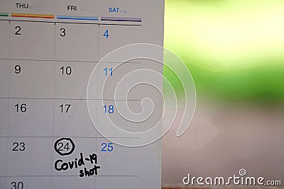 Covid-19 vaccine shot reminder on calendar. Stock Photo