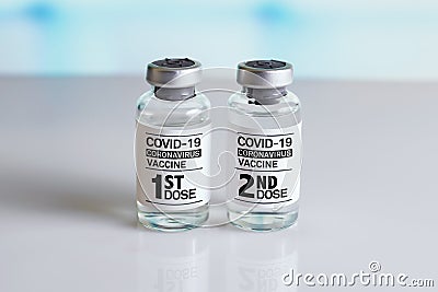 COVID-19 Vaccine Vials that require 2 injections tagged with 1st 2nd dose Stock Photo