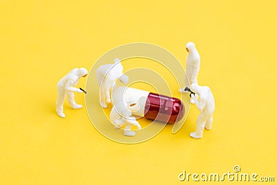 COVID-19 Virus medicine and vaccine research or novel coronavirus drug, miniature doctors wearing protective suit and mask Stock Photo