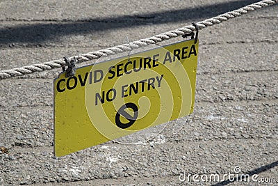 Covid warning notice hanging on a rope Editorial Stock Photo