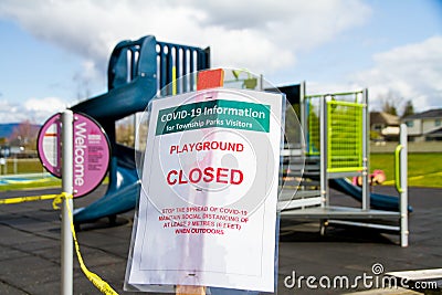 Covid-19 Warning Sign in front of Playground Stock Photo