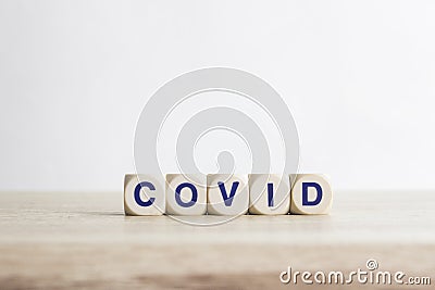 Covid - word from wooden blocks with letters on a table Stock Photo