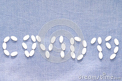 Covid 19 word written with diet nutrition capsules Stock Photo