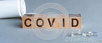 COVID word written on wood block. Covid text on grey table for your desing Stock Photo