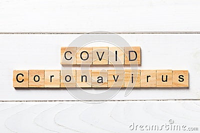 Covid word written on wood block. Covid text on wooden table for your desing, Wuhan Coronavirus, 2019-nCoV. concept top view Stock Photo