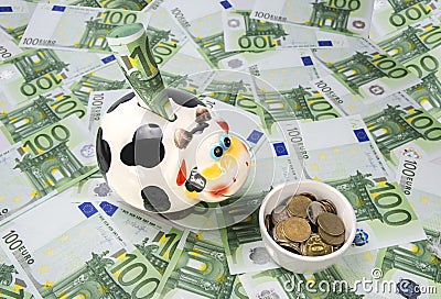 Cow a moneybox on a green field of euro Stock Photo