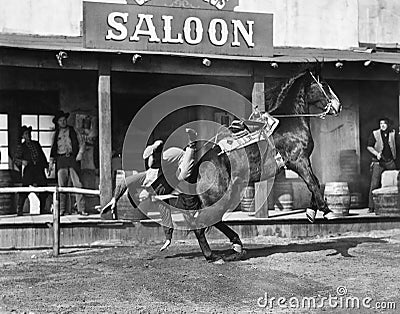 Cowboy being thrown off his horse Stock Photo