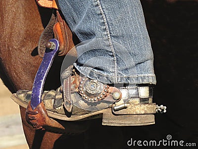 Cowboy boot in saddle stirrup Stock Photo
