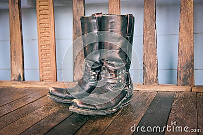 Cowboy Boots - American Wild West retro cowboy rodeo pair of traditional leather roper style western on wooden vintage style in Stock Photo