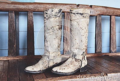 Cowboy Boots - American Wild West retro cowboy rodeo pair of traditional leather roper style western on wooden vintage style in Stock Photo