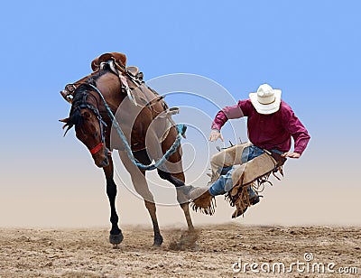 Cowboy bucked of a bucking Bronco Stock Photo
