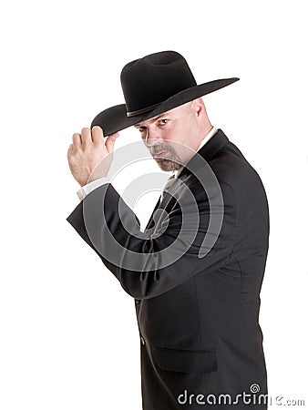 Cowboy businessman tipping hat Stock Photo