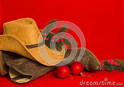 Cowboy Christmas.American West traditional boots and hat on christmas red background Stock Photo