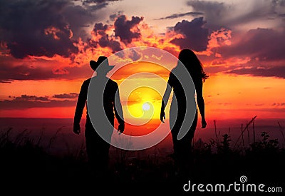 Cowboy couple silhouette at sunset Stock Photo