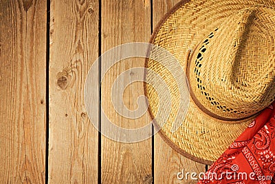 Cowboy hat on wooden vintage table with red bandanna for party invitation. Stock Photo