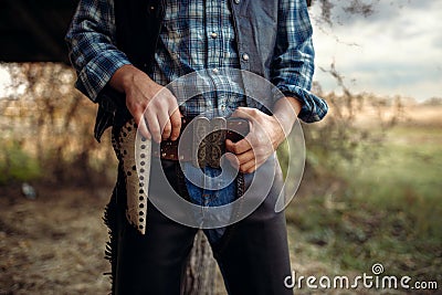 Cowboy with his hand on revolver, wild west Stock Photo