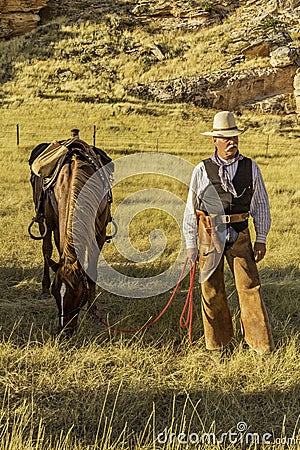 Cowboy by his Horse. Stock Photo