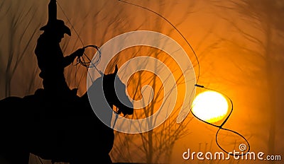 Cowboy on horse Lasso Roping Sun Stock Photo