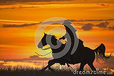 Cowboy on horseback silhouette Stock Photo
