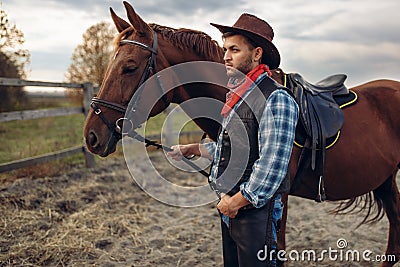 Cowboy poses with horse on texas farm Stock Photo